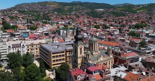 Panoramic View Of Sarajevo's Old Town With Churches, Mosques, And Red-roofed Houses On Sunny Day.