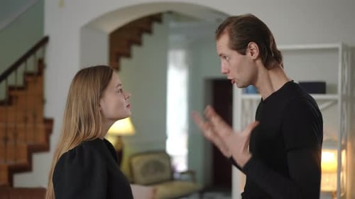 Couple Standing and Arguing Emotionally with Gestures in Modern Home Interior
