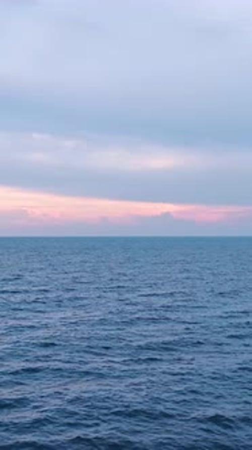 Vertical Video of a Beautiful Sunset Over the Ocean Captured From a Drone Perspective With a Soft