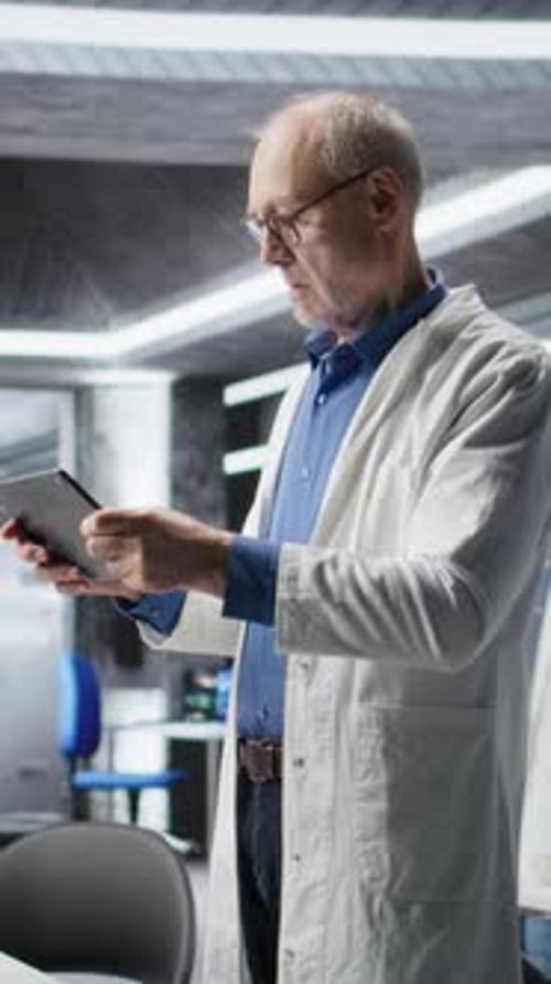 Vertical Video Male Researcher Focuses on Experiment Data in a Research Study