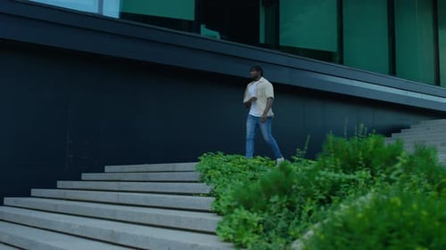 Man Walking Down Stairs in Urban Area