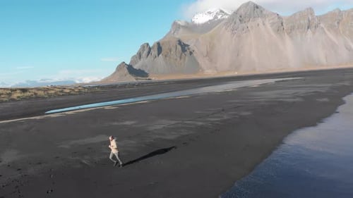Man running along Stokksnes beach