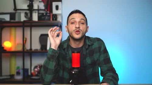 Man Speaking Into Microphone In Indoor Studio