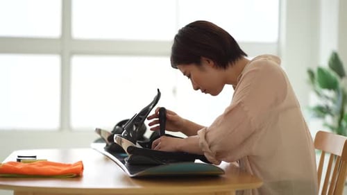 Woman taking care of snowboard board