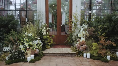 Wedding Venue Entrance Decorated With Flowers and Candles
