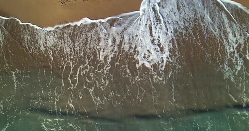 Aerial View of the Sea Waves Rolling Down the Sandy Beach