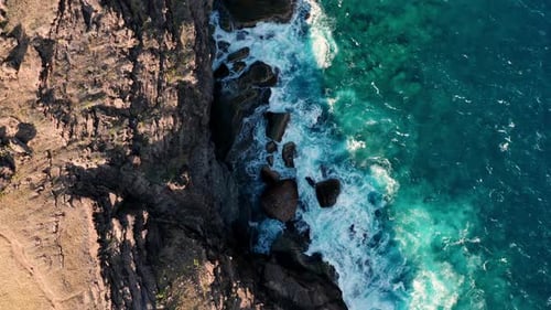Aerial shot of ocean coast with views of waves and cliffs