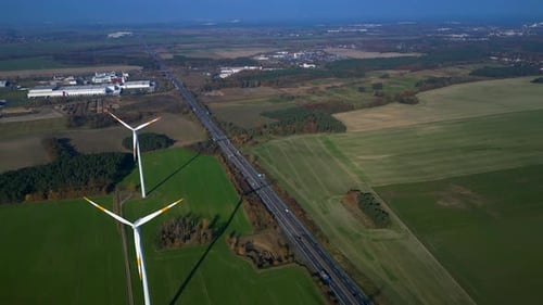 Wind farm Windmill turbines near highway clean energy. Best aerial view flight drone