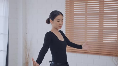 Elegant Dancer Practices Ballet in Bright White Studio