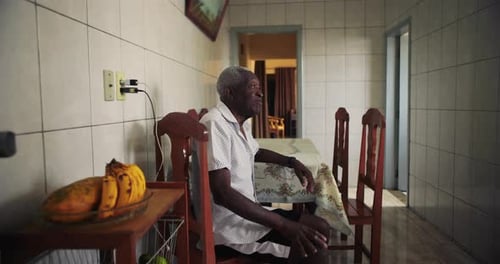 African American Elderly man in a moment of quiet reflection, thoughtful gaze and calm demeanor