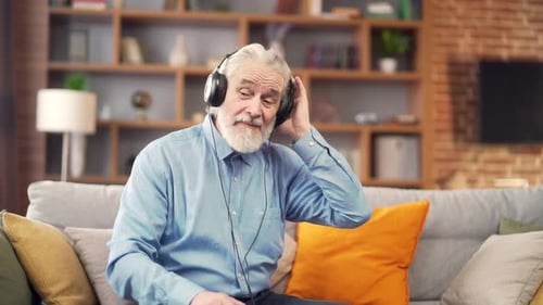 Senior Man Enjoys Music on Headphones