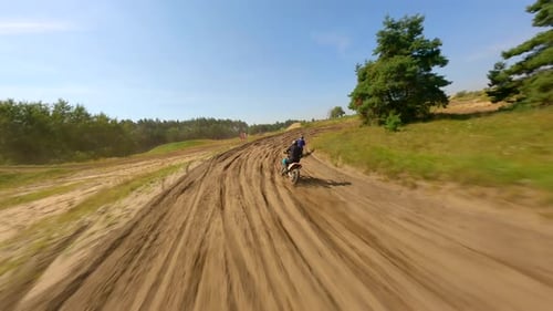 Dirtbikes Riding on Hilly Rural Track