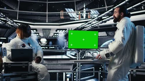 Astronauts in Advanced Technology Spacecraft Using Green Screen Monitor