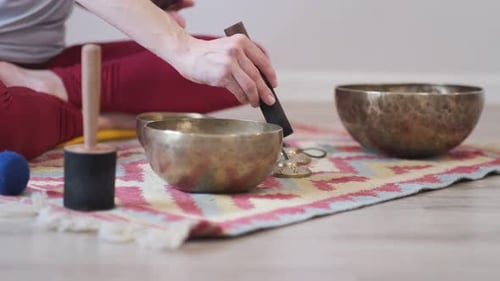Woman Plays Singing Bowls for Meditation and Relaxation