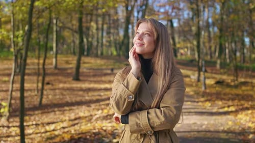 Cheerful Glad Woman Enjoying Sunny Autumn Weather in Park