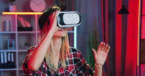 Close up portrait of woman which applying virtual reality headset during working at home in evening