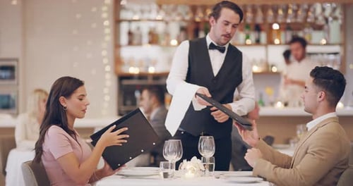 4k video footage of a waiter taking a couple's order in a restaurant