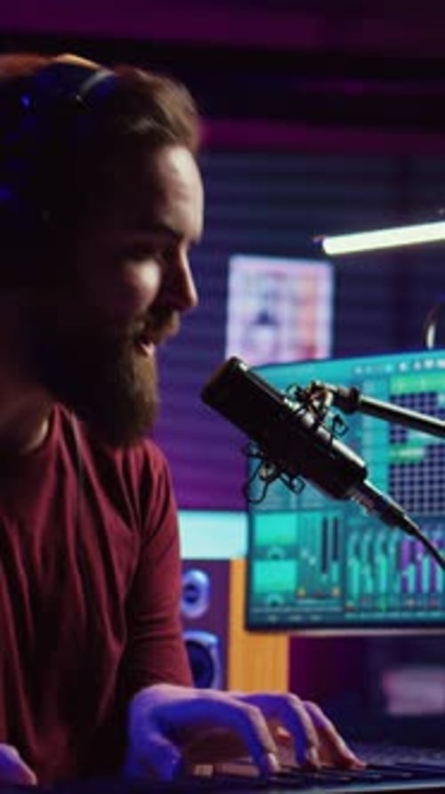 Young Adult Man Recording Music in Studio