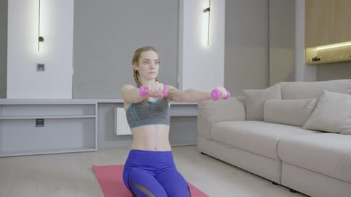 Woman Doing Arm Exercises with Dumbbells at Home