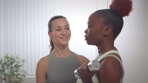 Women Working Out with Dumbbell Indoors Together