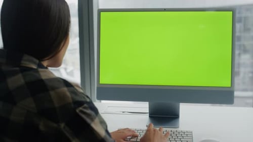 Woman Typing at Computer with Green Screen
