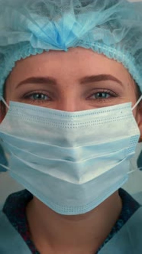 Portrait of female doctor removing medical face mask and smiling. Vertical video