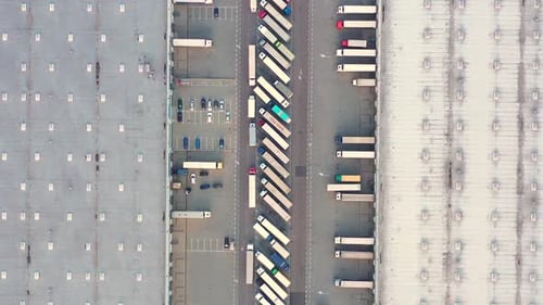 Top Down Aerial View of Busy Logistics Hub and Warehouse