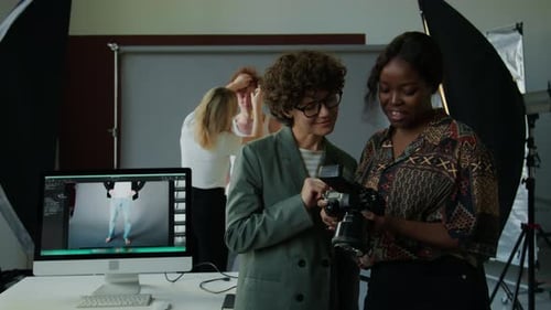 Photographer and Creative Director Discussing Photos in Studio