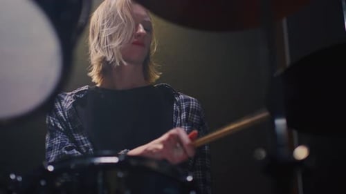 Woman Plays Drums on Stage Female Drummer in Rock Band Beating Rhythm on a Drum Kit Gril Musician
