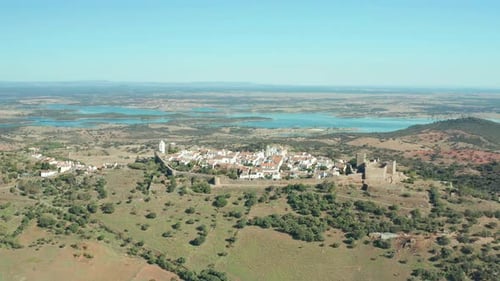 paradisiacal monsaraz castle with turquoise lake in iberian peninsula