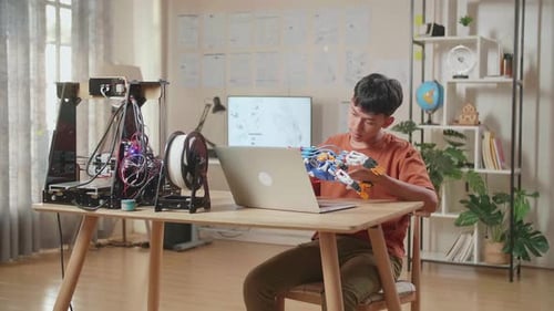 Young Adult Working with 3D Printer at Home