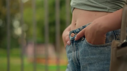 Trendy Woman Posing in Stylish Jeans and Top