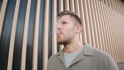 Portrait of Man Vaping Outdoors