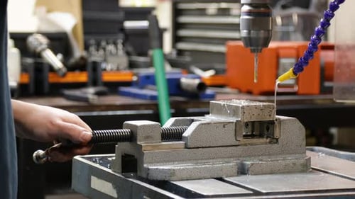 Drilling Metal Block On Drill Press, Closeup Shot