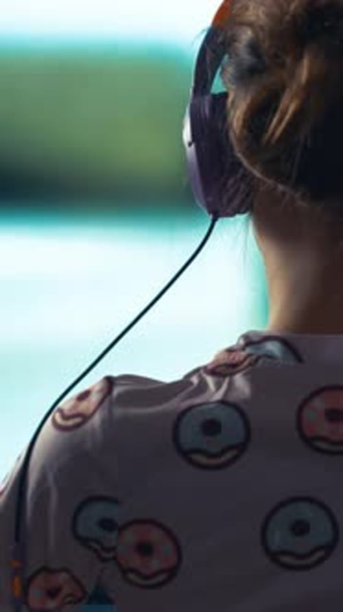 Girl with Headphones Viewing Computer Screen