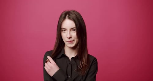 Young Woman Posing on a Pink Background
