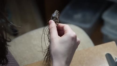 Woman Crafts Macrame Jewelry with Cording