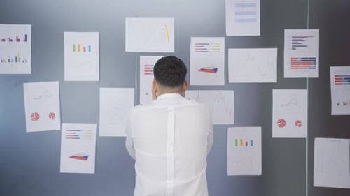 Charts, uneasy, unsuccessful businessman.
