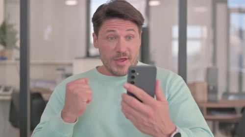 Excited Man Celebrating Good News on Phone