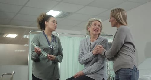 Doctor Talking to Patient in Hospital about Medical Test Result on Digital tablet
