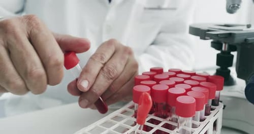 Scientist Caps Test Tube in Laboratory Close Up