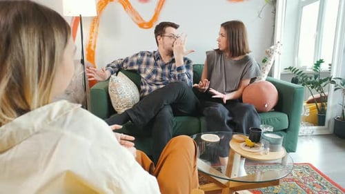 Couple conversing with a therapist in a bright living room