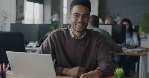 Young Adult Smiling in Modern Workplace Office
