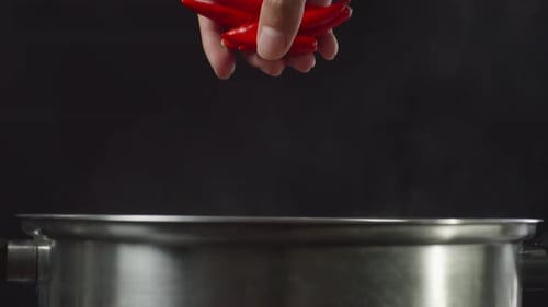 Close Up Of Chef's Hand Adding Chili In The Soup Pot. Sukiyaki Or Shabu In A Pot