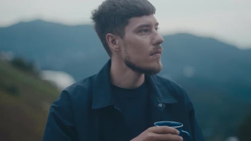 Man with Mug in Mountains