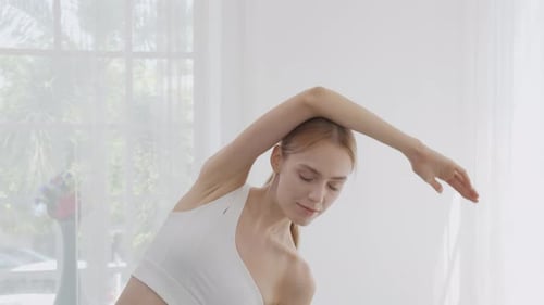 Woman with Fair Hair Stretching Inside Home