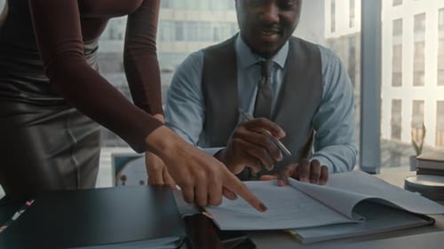 Businessman Signing Contract in Office with Colleague