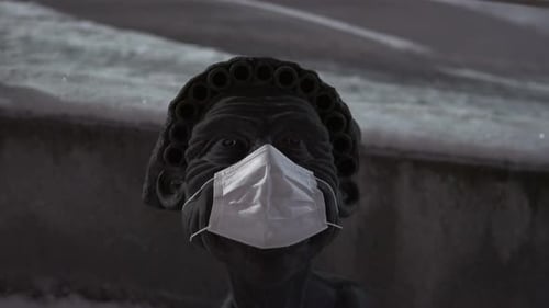 Statue wearing a face mask. Covid 19. Global pandemic. Abstract. Close up