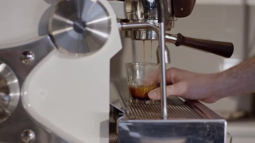 Espresso Machine Dispensing Coffee into Glass Close Up