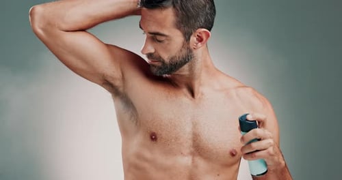 Handsome Man Using Deodorant